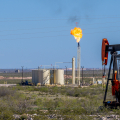 An oil and gas production site in a wide, arid landscape